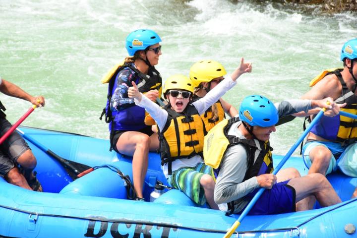 a group of people on a raft in a body of water