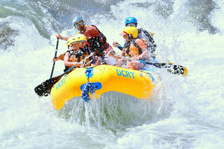 a man riding a wave on a surfboard jumping in the air
