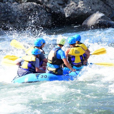 a group of people riding skis on a raft in the water