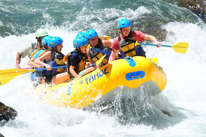 a man riding a wave on a raft in the water