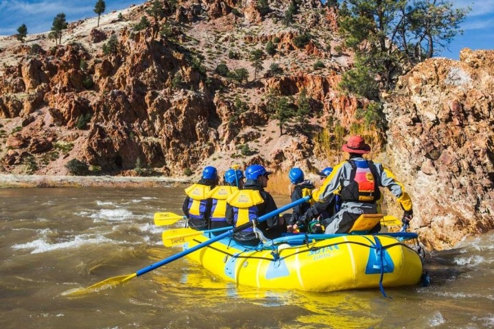 a man riding on a raft in a body of water