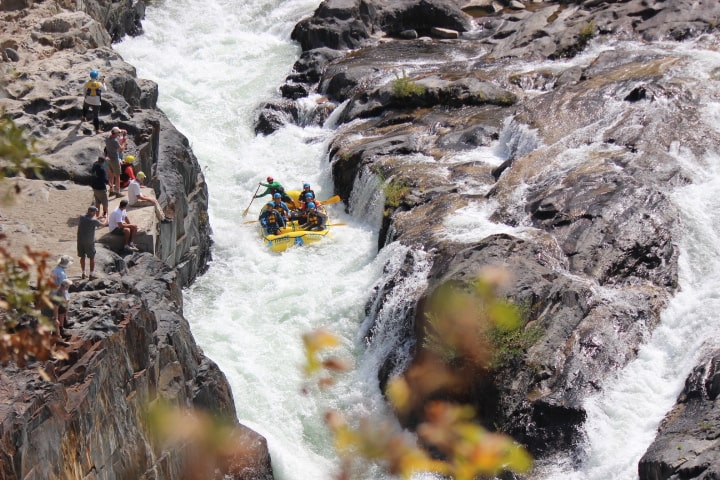 a pile of snow next to a waterfall