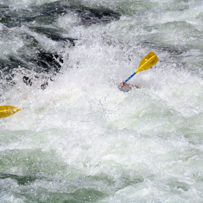 a man riding a wave on a surf board on a body of water