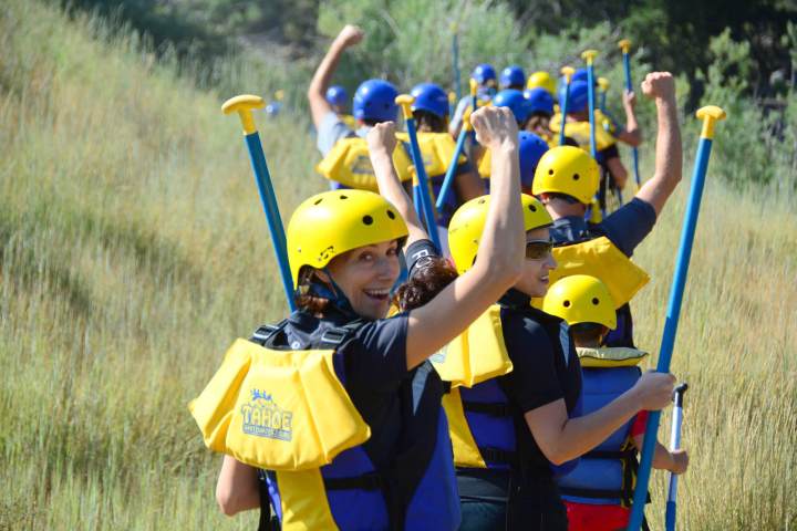 a boy wearing a helmet and holding a baseball bat