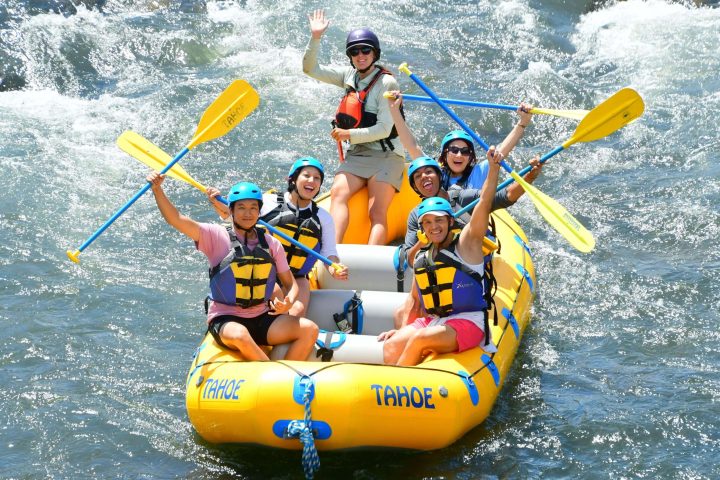 a group of people on a raft in the water