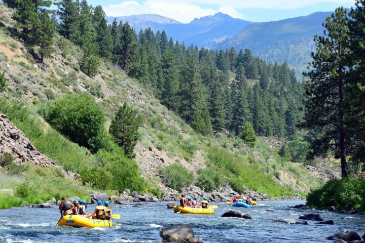 a small boat in a body of water with a mountain in the background