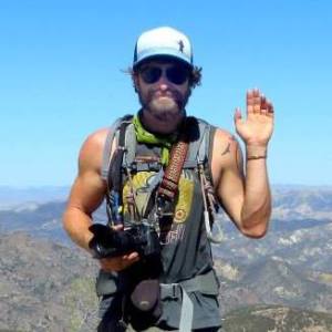 a man wearing sunglasses posing for the camera