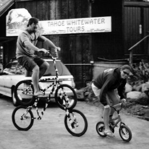 a group of people riding on the back of a bicycle