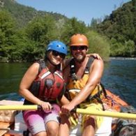 a group of people rowing a boat in a body of water