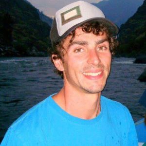 a man standing next to a body of water