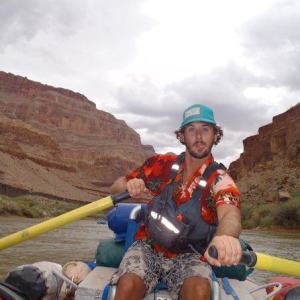 a man riding a motorcycle with a mountain in the background