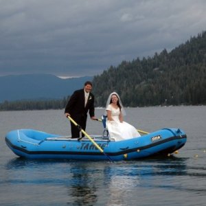 a man riding on the back of a boat in the water