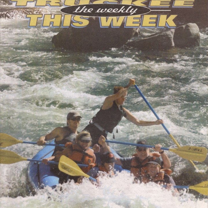 a group of people riding on the back of a boat in the water