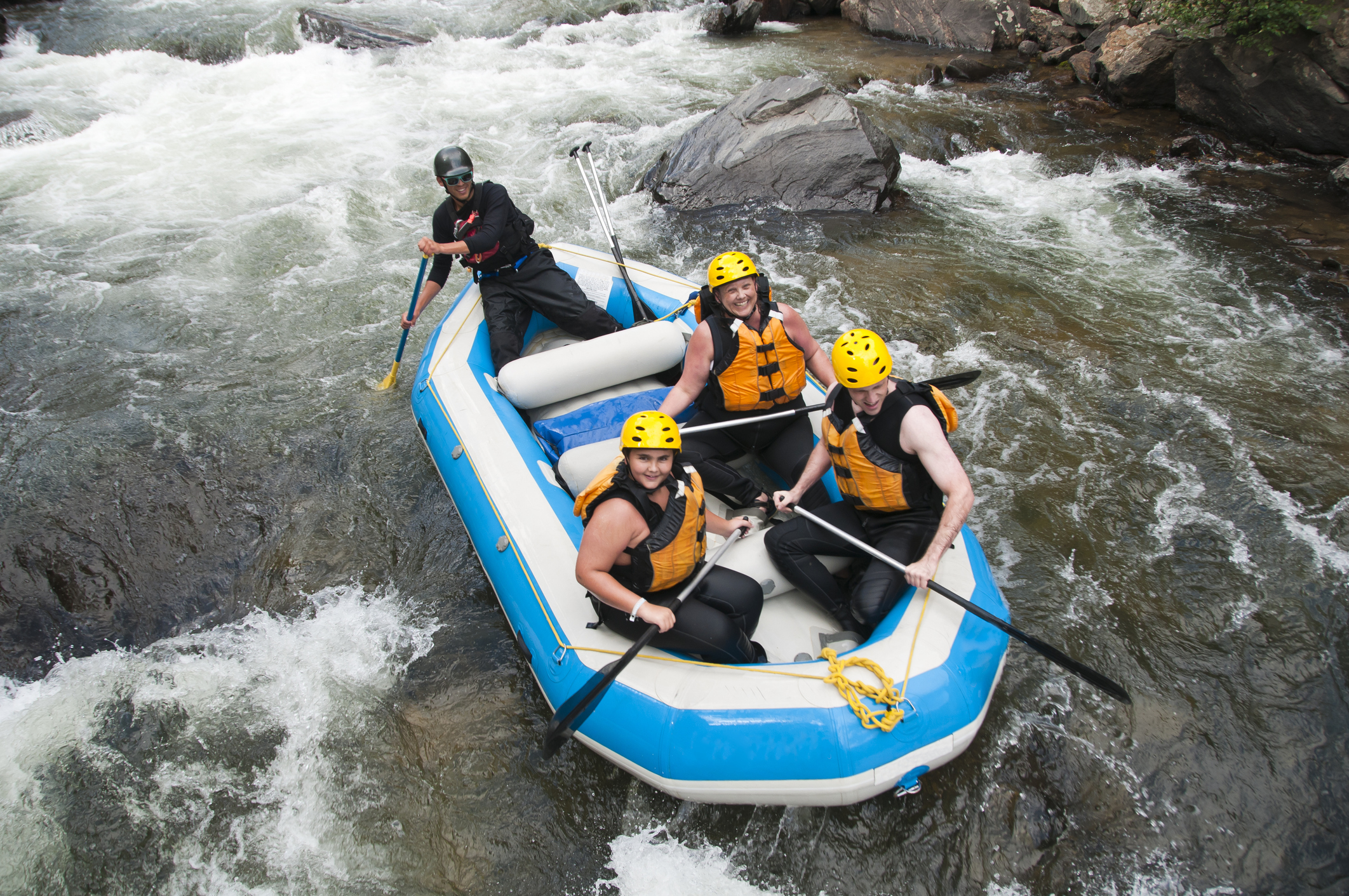 Three people enjoy family-friendly whitewater rafting near Lake Tahoe, CA.