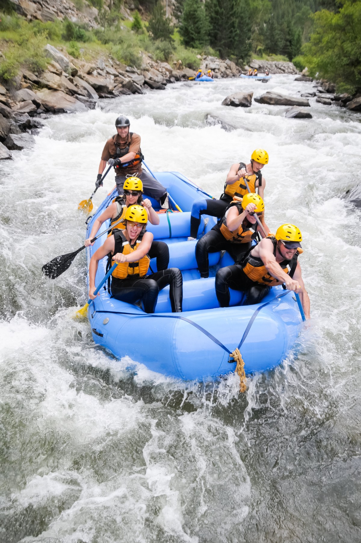 A group of friends whitewater rafting near Auburn, CA.